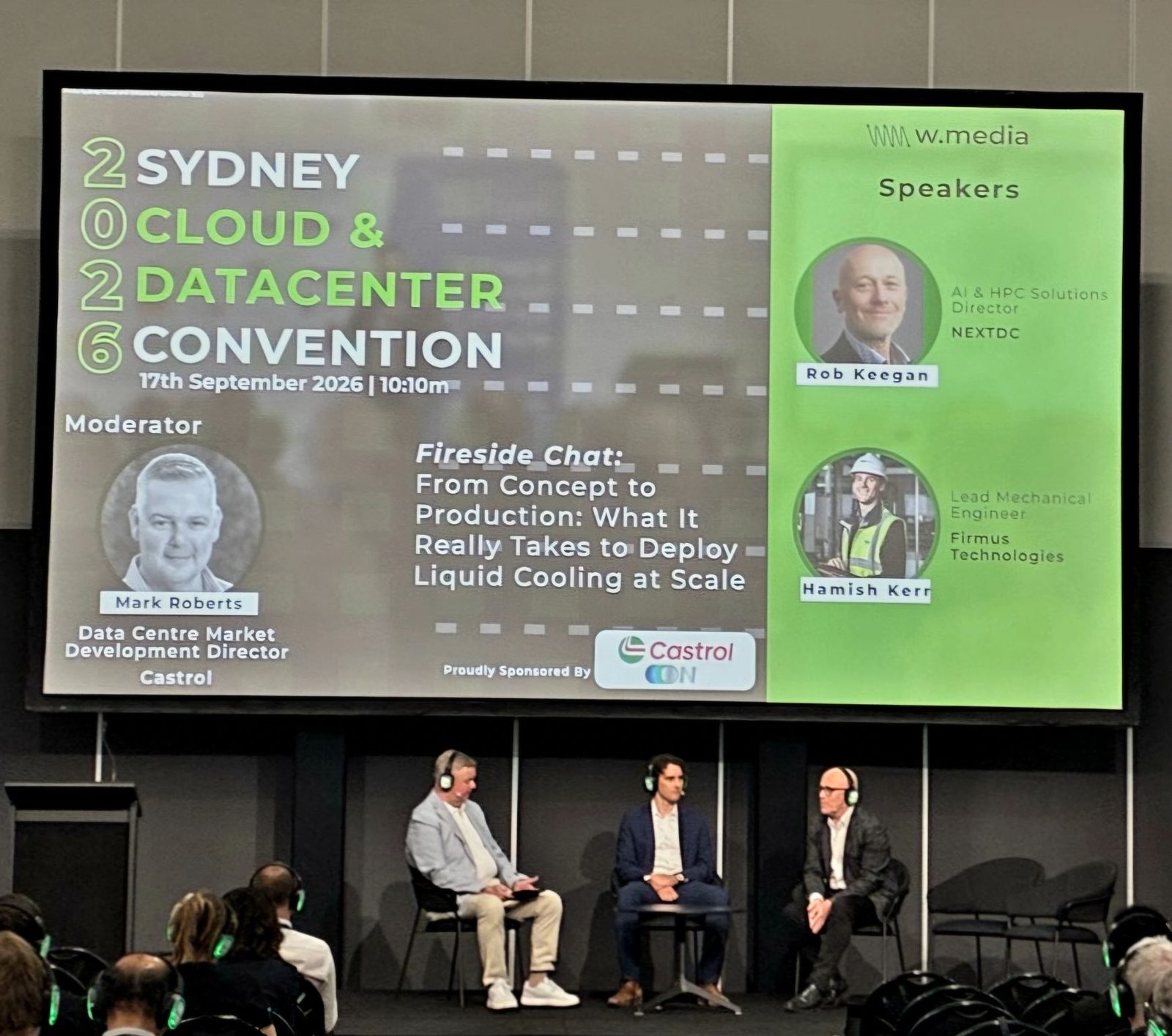 Panel session on stage at the Sydney Cloud and Datacenter Convention 2026, with the fireside chat title slide on liquid cooling displayed on the screen above.